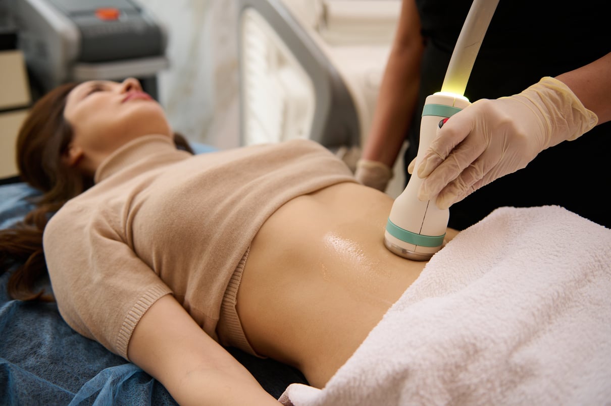 Sculpting Machine on a Woman's Stomach 